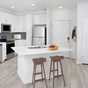 Kitchen with island and stainless steel appliances at Camden Montague apartments in Tampa, FL