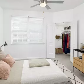 Bedroom with carpet flooring, ceiling fan, and walk-in closet at Camden Montague apartments in Tampa, FL