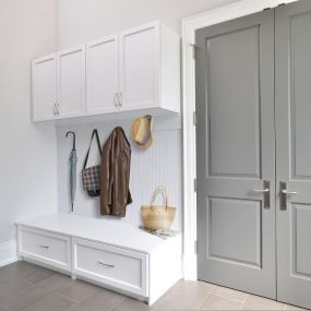 Mudrooms are an excellent way to store every day items and provide a space for people to change into and out of outdoor clothing and shoes. Mudrooms are often located near the entrance of the home and are designed with cabinets, cubbies, hooks, drawers, and benches to keep shoes and coats organized