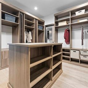 Master bedroom closet remodel with cabinets and island
