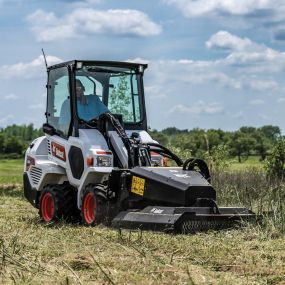 A Bobcat L23 with a Brushcat attachment