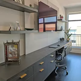This beautiful built-in desk is the perfect place to catch up on work in style. With flowing natural light, floating shelves, custom brass drawer pulls and elegant dark hardwoods, its an exercise in both style and substance.