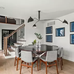 Sleek, elegant, full of style. This dining space by Balbes Custom Builders features elegant new lighting, beautiful wood floors, and ample space to relax and unwind. Perfect for gathering, cooking, and creating memories.