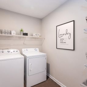 Laundry room with full size washer/dryer and shelving at Camden Reunion Park