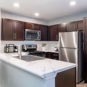 Modern style kitchen with espresso cabinets at Camden Reunion Park