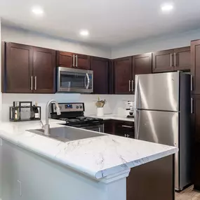 Modern style kitchen with espresso cabinets at Camden Reunion Park