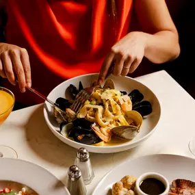 Seafood Tagliatelle: clams, PEI mussels, shrimp, squid, shaved parmesan cheese, white wine saffron sauce