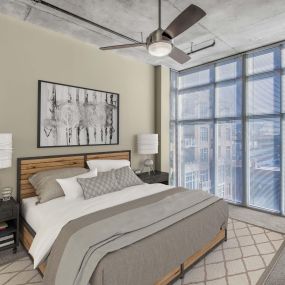 Bedroom with floor to ceiling windows ceiling fan and carpet flooring