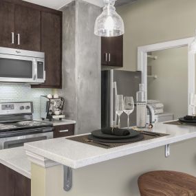 Kitchen with quartz countertop island pendant lighting and laundry room with full size washer and dryer