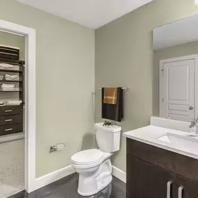 Bathroom with glass shower and closet with wood organization system