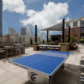 Rooftop outdoor lounge with ping pong table and tvs