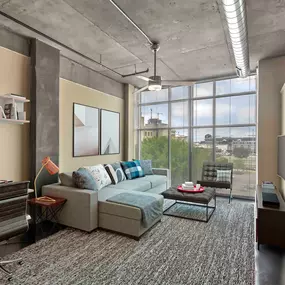 Living room with work from home space and floor to ceiling windows