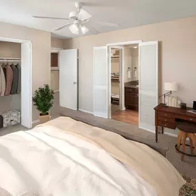 Bedroom with work from home area ceiling fan and large closet