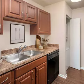 Kitchen with stainless steel appliances and stacked washer and dryer closet at Camden Valley Park