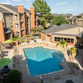 Aerial view of pool with sundeck and outdoor dining areas