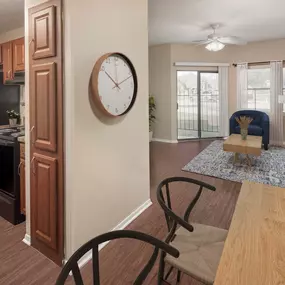 First-floor kitchen, dining and living room with wood-style flooring and patio access at Camden Valley Park