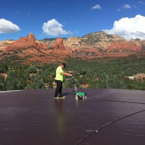 Worker installing a new flat roof. Hahn Roofing, Sedona, AZ