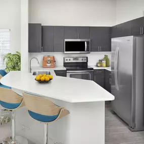 Kitchen with stainless steel appliances at Camden Lee Vista apartments in Orlando, FL