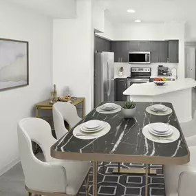 Dining and kitchen with wood-look flooring throughout at Camden Lee Vista apartments in Orlando, FL