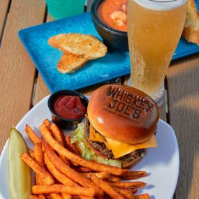 Signature Burger served with fries and a cold beer