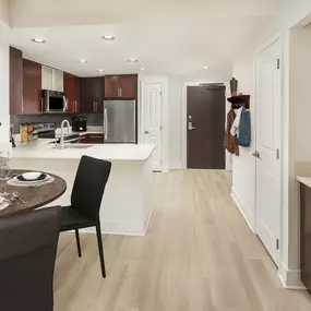 Warm modern style features open-concept living spaces with wood-look flooring throughout at Camden NoMa apartments in Washington, D.C.