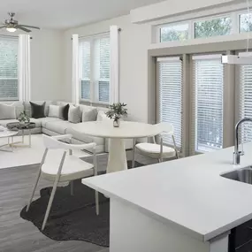 Kitchen overlooking spacious, open-concept living and dining area with wood-style floors at Camden Victory Park apartments in Dallas, TX