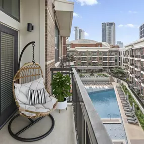 Private balcony overlooking the pool and American Airlines Center at Camden Victory Park apartments in Dallas, TX