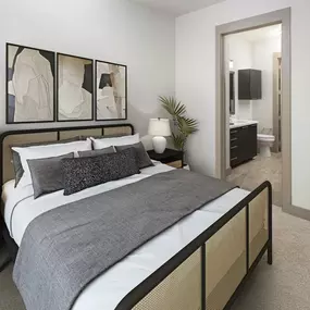 Spacious bedroom with carpet and ensuite at Camden Victory Park apartments in Dallas, TX