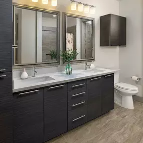 Bathroom with two sinks, linen storage and a large walk-in closet