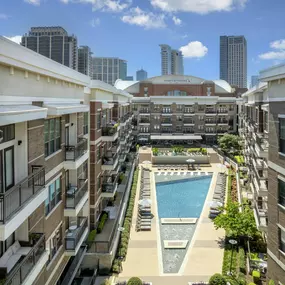 Aerial view of resort-style pool and sundeck with American Airlines Center in the background at Camden Victory Park apartments in Dallas, TX