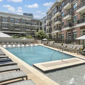 Resort-style pool and sundeck lined with lounge chairs at Camden Victory Park apartments in Dallas, TX