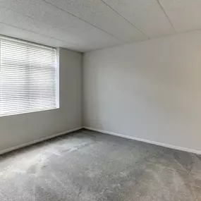 Empty room with a window and concrete floor