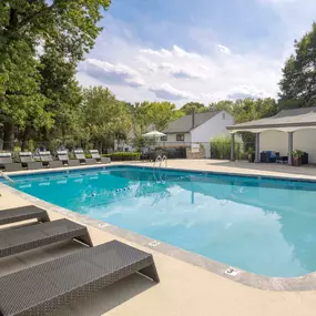 Resort-style pool with bbq grills and outdoor dining