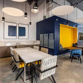 The hub community workspace with dining table and seating options for work stations