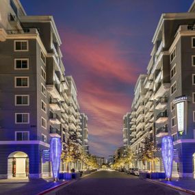 Camden Harbor View Apartments at dusk with retail spaces below homes