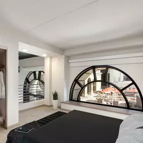 Loft style living space with arched window in live work home