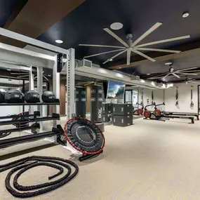 Fitness center with trx bands trampoline rowing machines boxing bag and rope