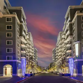 Camden Harbor View Apartments at dusk with retail spaces below homes