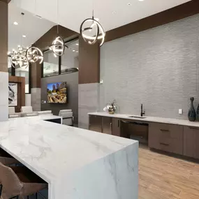 Resident club demo kitchen with barstool seating and quartz countertops