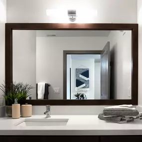 Modern style bathroom with white quartz countertops and nickel hardware