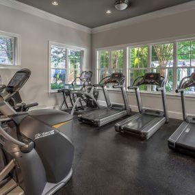 Fitness center with cardio equipment overlooking pool