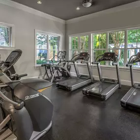 Fitness center with cardio equipment overlooking pool