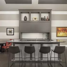 Resident lounge with entertaining kitchen and poker table at Camden Fallsgrove apartments in Rockville, MD