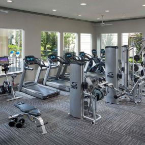 24-hour fitness center with cardio and strength training equipment