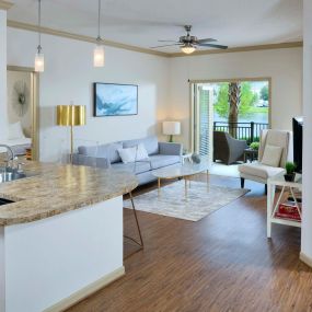 Open concept kitchen living room with wood inspired flooring