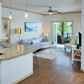 Open concept kitchen living room with wood inspired flooring