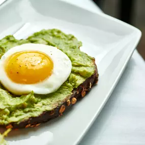 Avocado Toast - grilled sourdough, soft poached eggs, sprouts, radish, salad