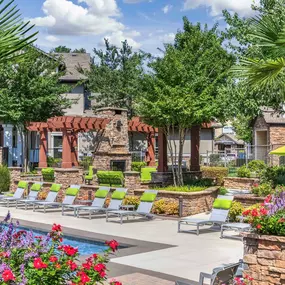 Relax on our beautiful pool deck with lounge chairs at Camden Asbury Village in Raleigh, NC.