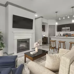 Open concept kitchen and living room at Camden Asbury Village in Raleigh, NC.  The kitchen features stainless steel appliances and a built-in desk with shelving.  The living room features an electric fireplace.