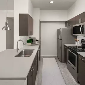 Kitchen with gray quartz countertops and stainless steel appliances at Camden Caley in Englewood, CO